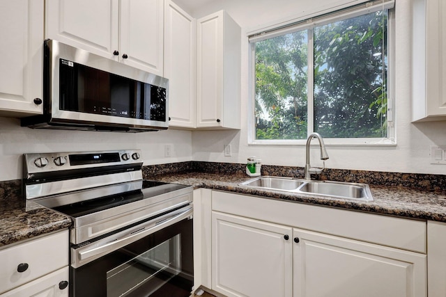 kitchen featuring white cabinetry, a healthy amount of sunlight, appliances with stainless steel finishes, and sink