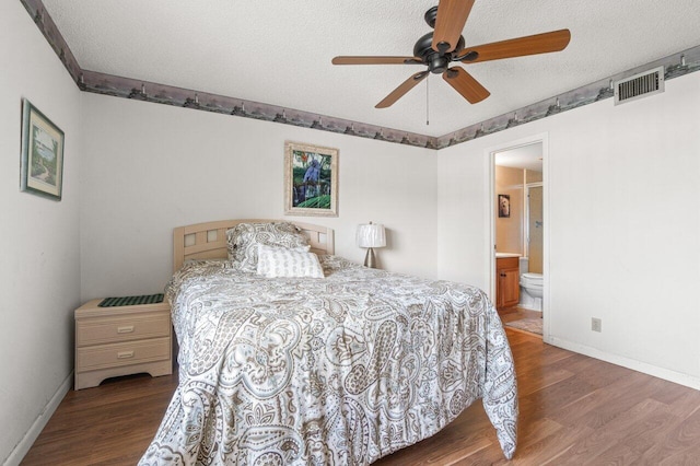 bedroom with connected bathroom, ceiling fan, hardwood / wood-style flooring, and a textured ceiling