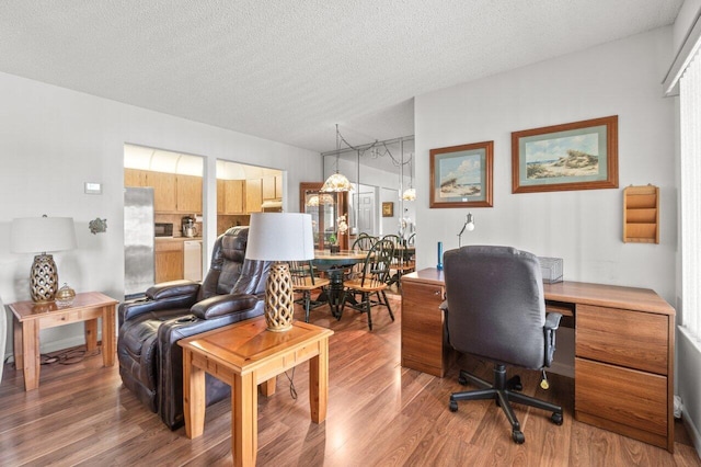 office area featuring hardwood / wood-style flooring and a textured ceiling