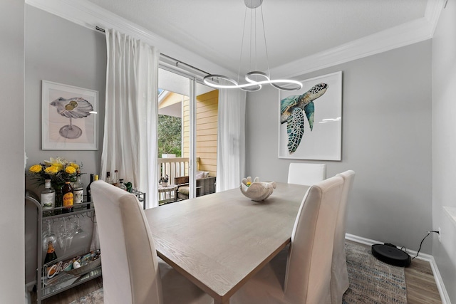 dining space featuring crown molding and dark hardwood / wood-style floors