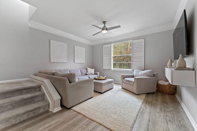 living room with ceiling fan, ornamental molding, and light wood-type flooring