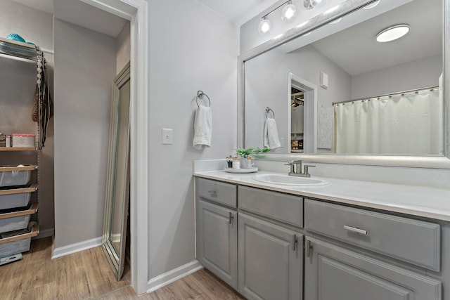 bathroom featuring vanity, hardwood / wood-style floors, and a shower with shower curtain