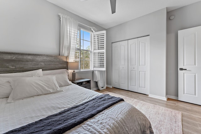 bedroom featuring ceiling fan, light hardwood / wood-style floors, and a closet