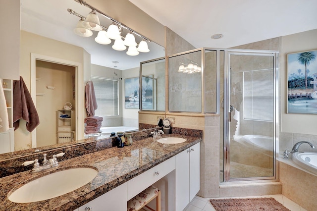 bathroom with vanity, tile patterned flooring, and plus walk in shower