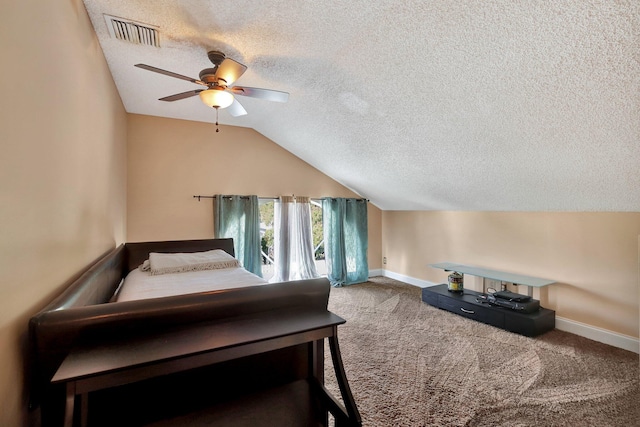 carpeted bedroom with a textured ceiling, vaulted ceiling, and ceiling fan