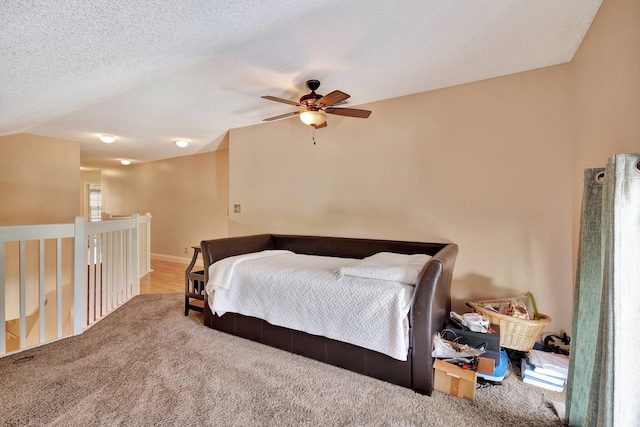 bedroom featuring a textured ceiling, carpet floors, and ceiling fan