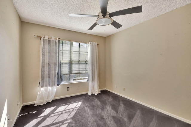 empty room with ceiling fan, a textured ceiling, and dark colored carpet