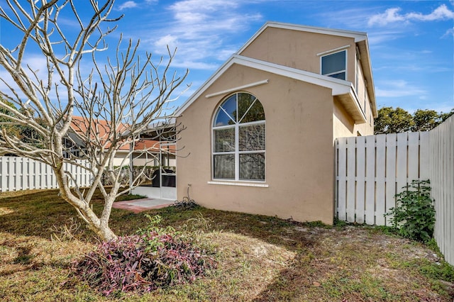 view of side of home with a lawn