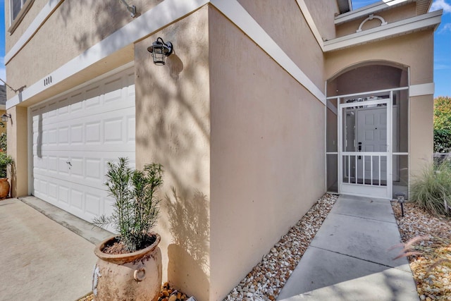 view of exterior entry featuring a garage