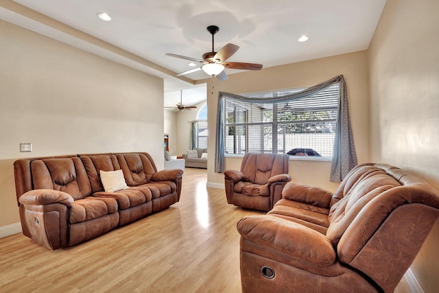 living room with ceiling fan and light hardwood / wood-style flooring