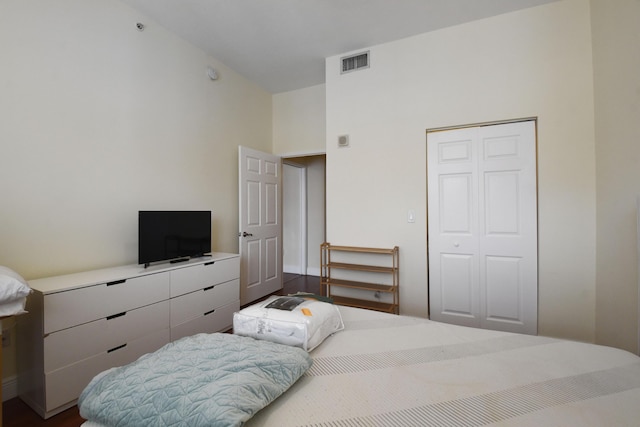 bedroom with wood-type flooring and a closet