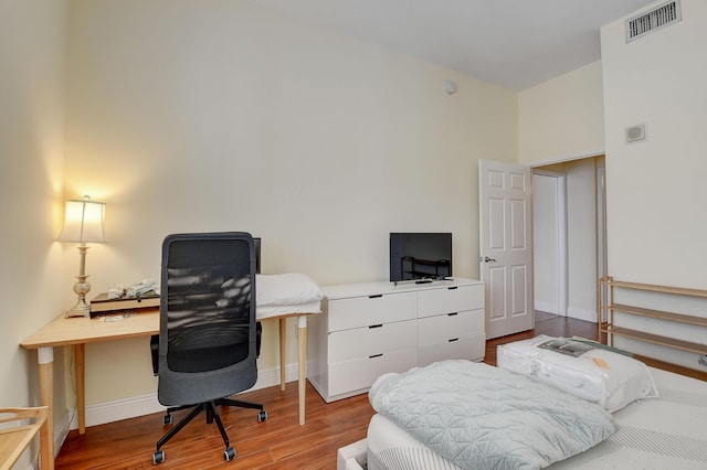 bedroom with hardwood / wood-style flooring