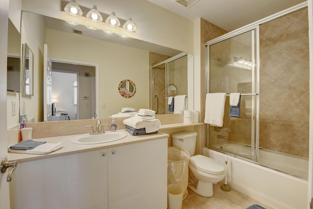 full bathroom featuring vanity, tile patterned floors, enclosed tub / shower combo, and toilet