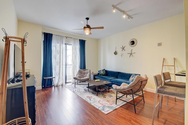 living room with track lighting, dark hardwood / wood-style floors, and ceiling fan