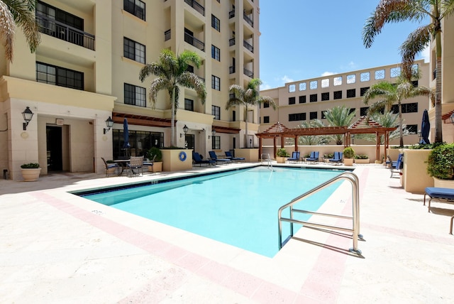 view of pool featuring a pergola and a patio