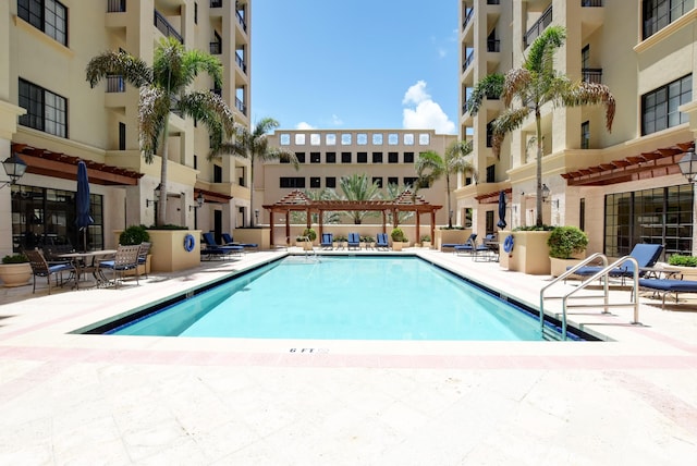 view of swimming pool featuring a pergola and a patio area