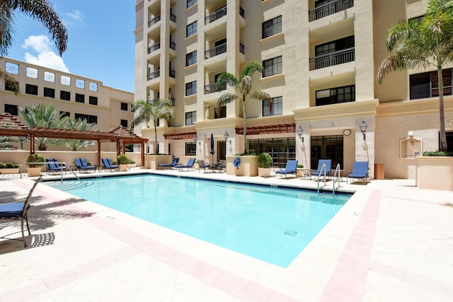 view of swimming pool featuring a pergola and a patio area