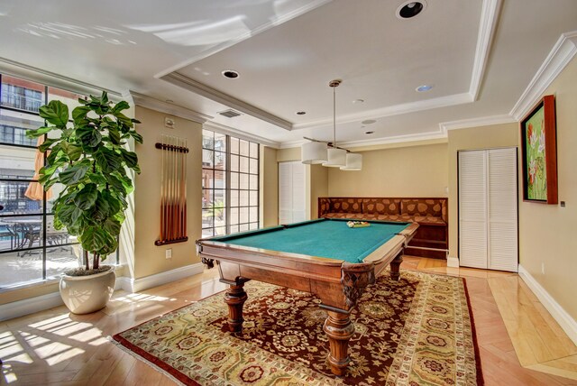 playroom with crown molding, billiards, a raised ceiling, and light hardwood / wood-style flooring