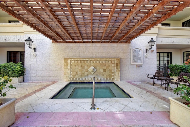 view of swimming pool with a hot tub, a pergola, and a patio