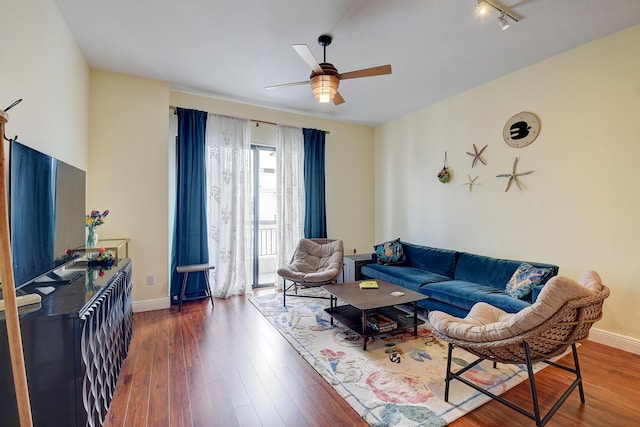 living room with ceiling fan and dark hardwood / wood-style floors