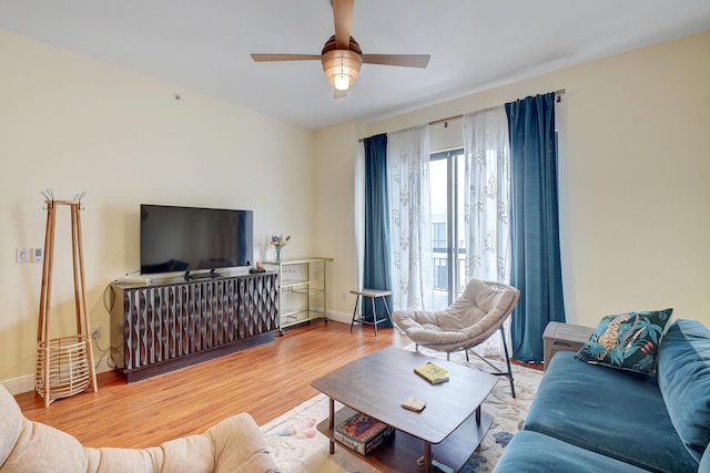 living room featuring ceiling fan and light wood-type flooring