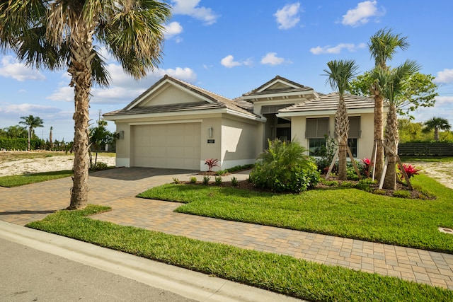 view of front facade with a garage and a front lawn