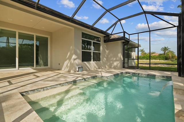 back of property featuring pool water feature, a lanai, and a patio