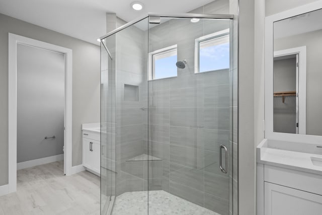 bathroom featuring vanity, hardwood / wood-style floors, toilet, and walk in shower