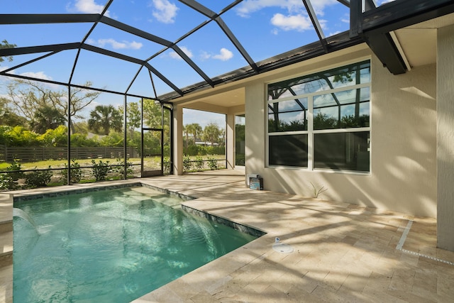 view of pool with a patio area and glass enclosure