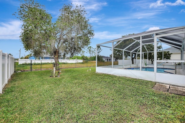 view of yard with a lanai and a fenced in pool