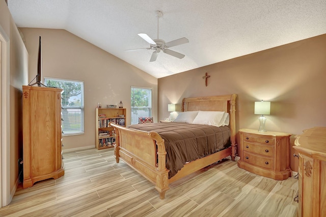 bedroom featuring lofted ceiling, a textured ceiling, and ceiling fan