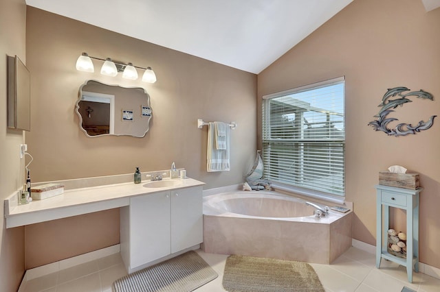 bathroom with vanity, lofted ceiling, a washtub, and tile patterned floors