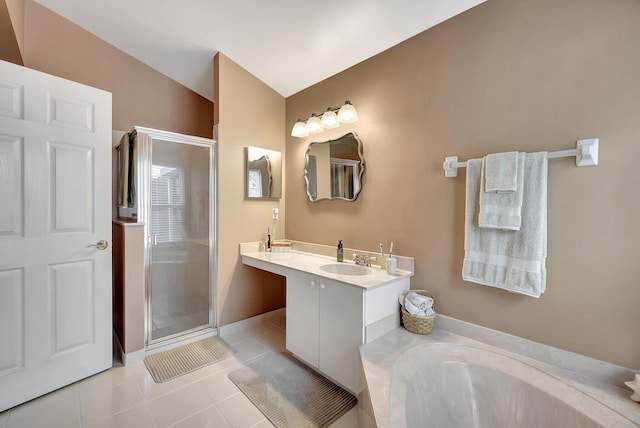 bathroom with vaulted ceiling, vanity, plus walk in shower, and tile patterned flooring