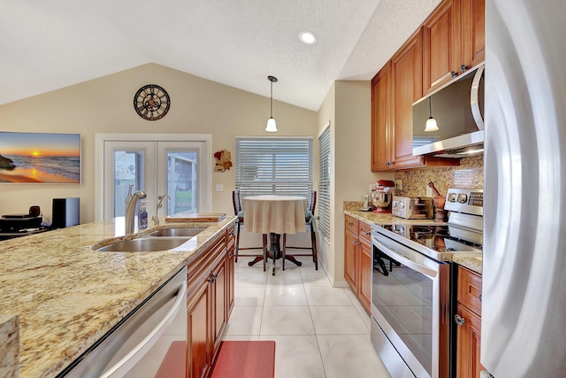 kitchen with sink, appliances with stainless steel finishes, tasteful backsplash, decorative light fixtures, and french doors