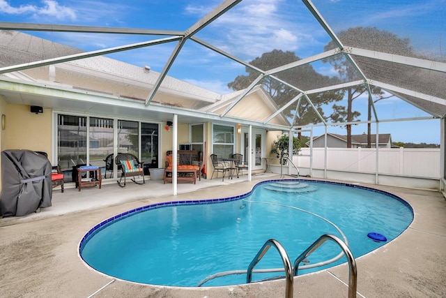 view of pool with area for grilling, a lanai, and a patio area