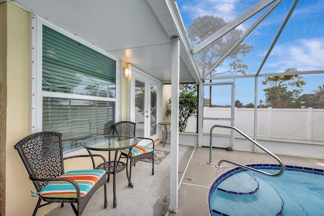 sunroom featuring a healthy amount of sunlight and french doors