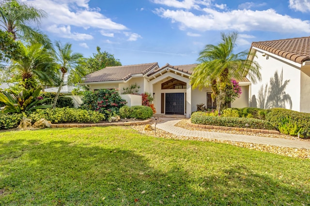 mediterranean / spanish house featuring a front yard