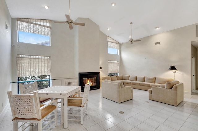 living room with light tile patterned flooring, high vaulted ceiling, and ceiling fan