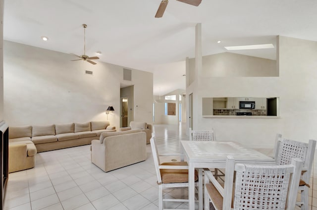 tiled dining room with high vaulted ceiling and ceiling fan