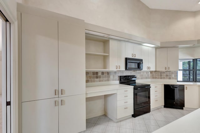 kitchen featuring white cabinetry, backsplash, light tile patterned floors, and black appliances