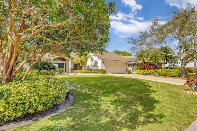 view of front of property featuring a garage and a front yard