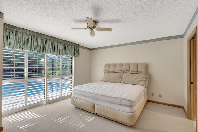 carpeted bedroom featuring ceiling fan, a textured ceiling, and access to outside