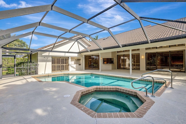 view of pool featuring an in ground hot tub, a lanai, and a patio