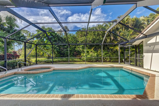 view of pool with a lanai and an in ground hot tub