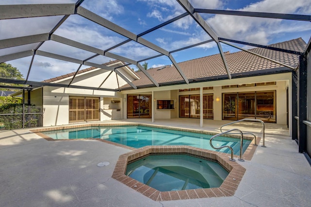 view of swimming pool with a lanai, a patio, and an in ground hot tub