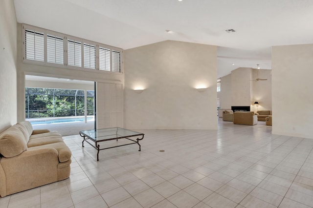 living room featuring high vaulted ceiling and light tile patterned floors