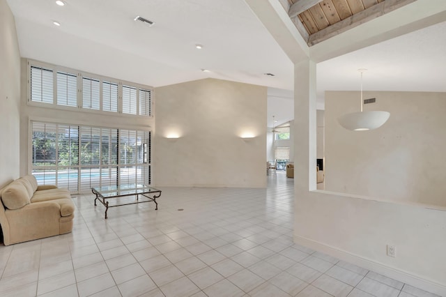 tiled living room featuring beamed ceiling, high vaulted ceiling, and a healthy amount of sunlight