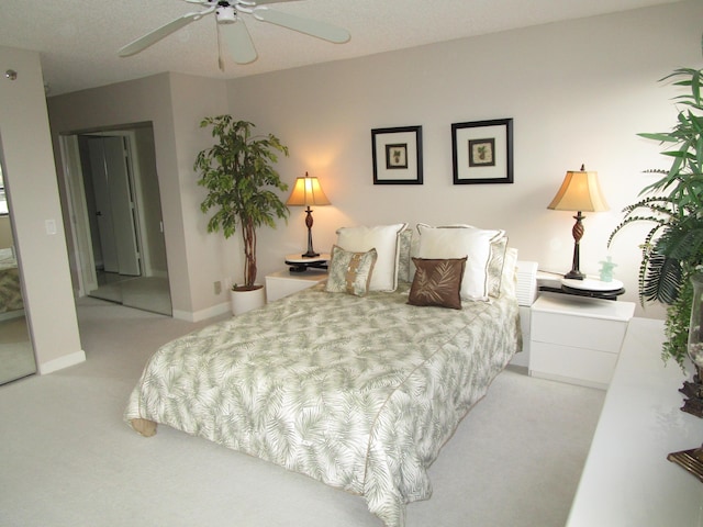 bedroom with light colored carpet and ceiling fan