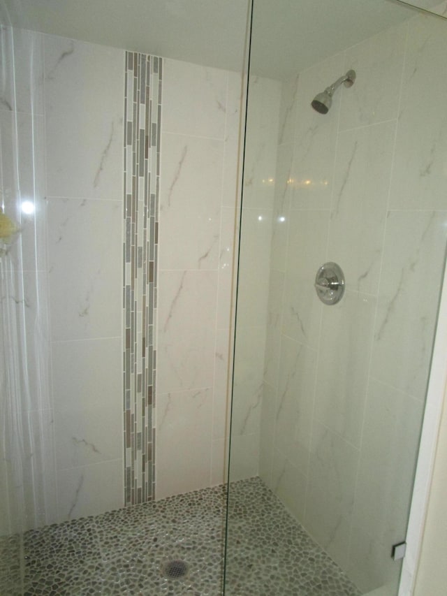 bathroom with tiled shower