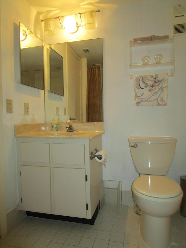 bathroom featuring tile patterned floors, vanity, toilet, and curtained shower